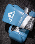 Blue boxing gloves on a black surface, limited edition release.