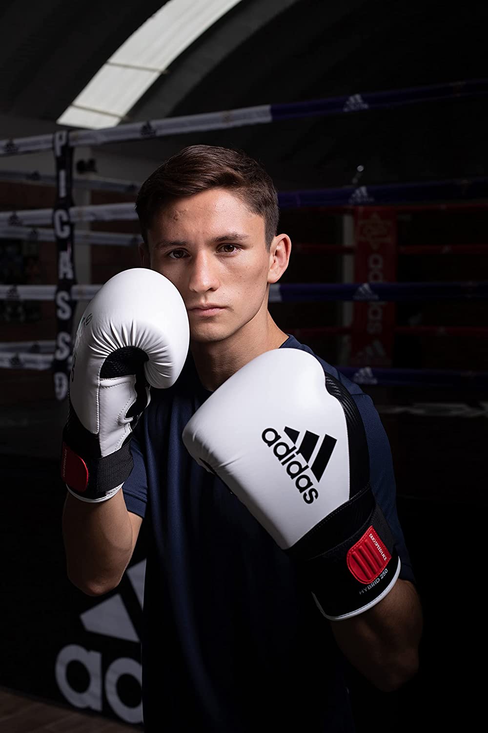 Man wearing boxing gloves for training.