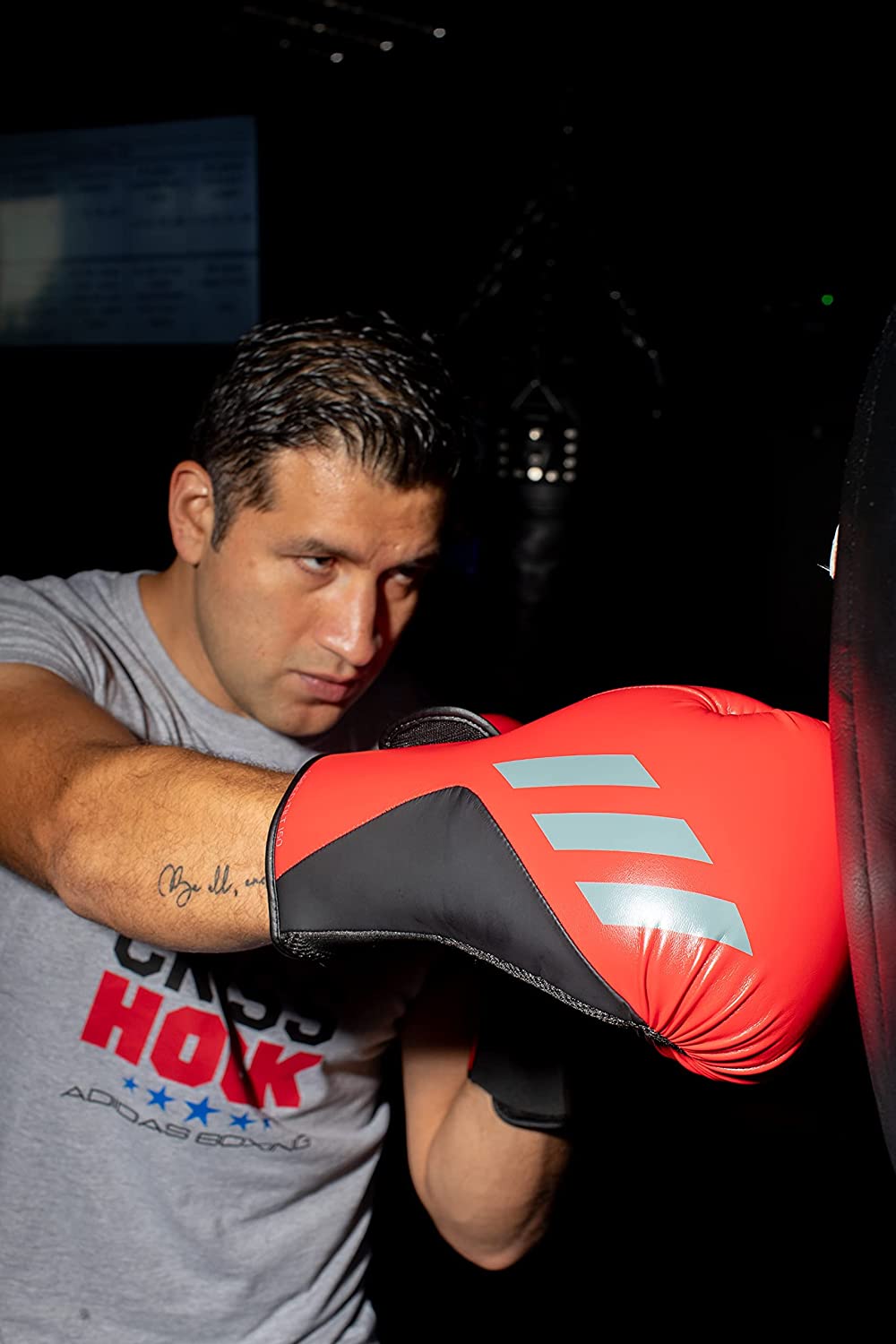 Man punching a punching bag during workout session.