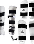 White and black shin guards for taekwondo sparring.