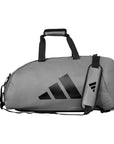 Grey duffel bag with black straps for sports and travel.