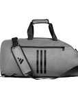 Grey duffel bag with black straps, adidas Combat Sports bag viewed sideways.