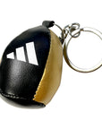 Close up of black and gold Adidas keychain accessory.