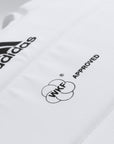 Close-up of Adidas logo on karate body protector.