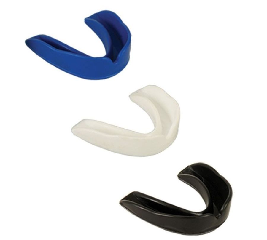 Set of different colored mouth guards made of thermoformable material.