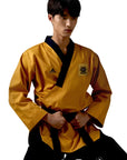 Man wearing a yellow taekwondo uniform with black belt.