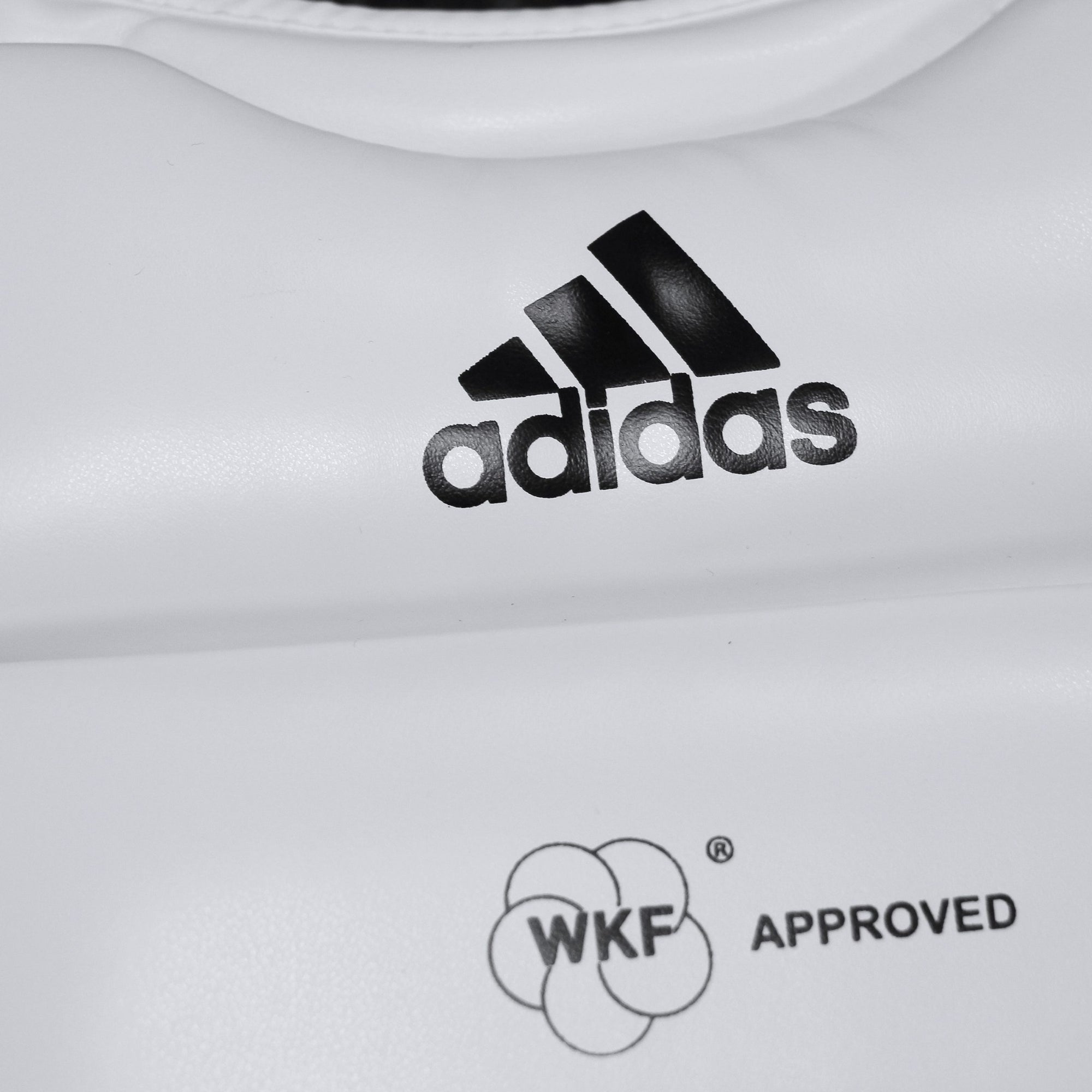 Close up of Adidas logo on Plastron chest guard, size XS.