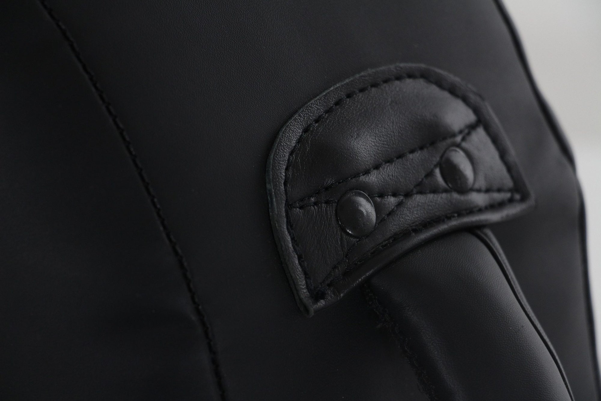 Close-up view of a black leather bag.