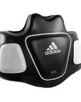 Black and white Adidas boxing pad used for coaching.