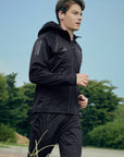 Man running in a black jacket from adidas Men's Hydrosuit adiSS23.