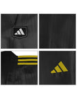 Close-up of a black sports jacket with Adidas logos and details.