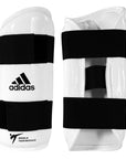 A pair of black and white Adidas vinyl forearm guards for sparring.