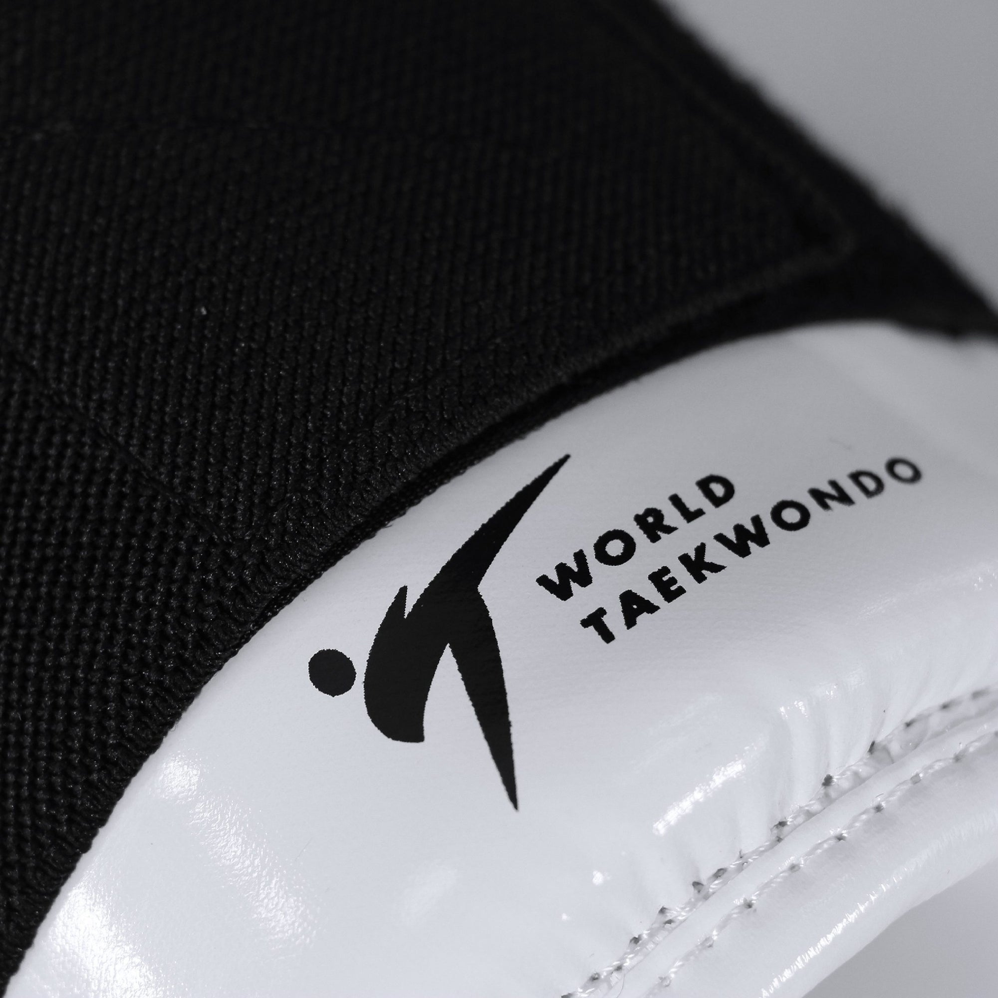 Close-up of a black and white taekwondo glove.