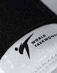 Close-up of a black and white taekwondo glove.