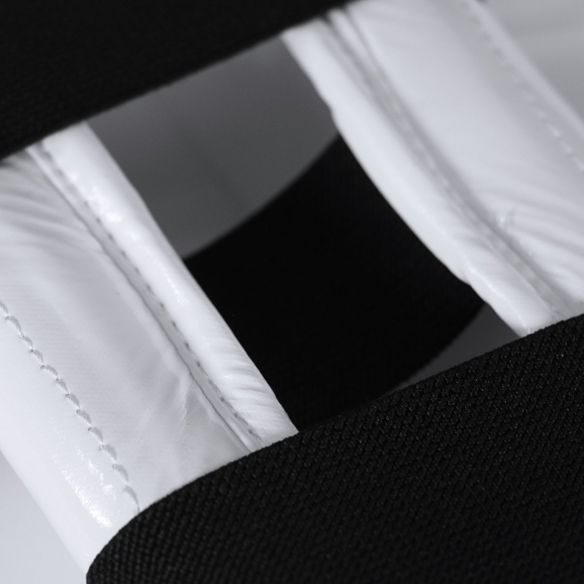 Close-up of a white and black taekwondo belt.