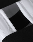 Close-up of a white and black taekwondo belt.