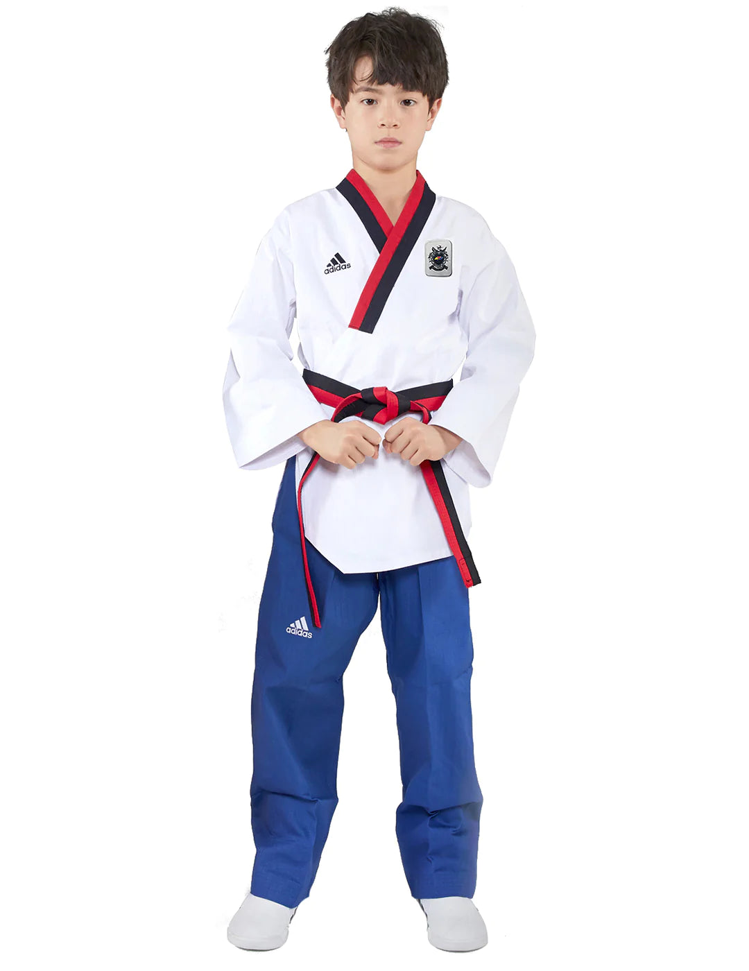 Boy wearing Adidas Poomsae taekwondo uniform in white and blue.