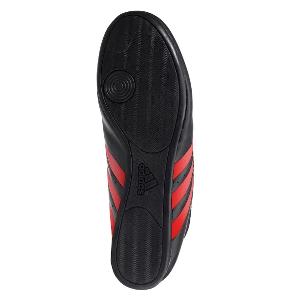 Black and red adidas laceless taekwondo shoe.