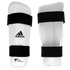 White and black Adidas vinyl shin guards for Taekwondo sparring gear.