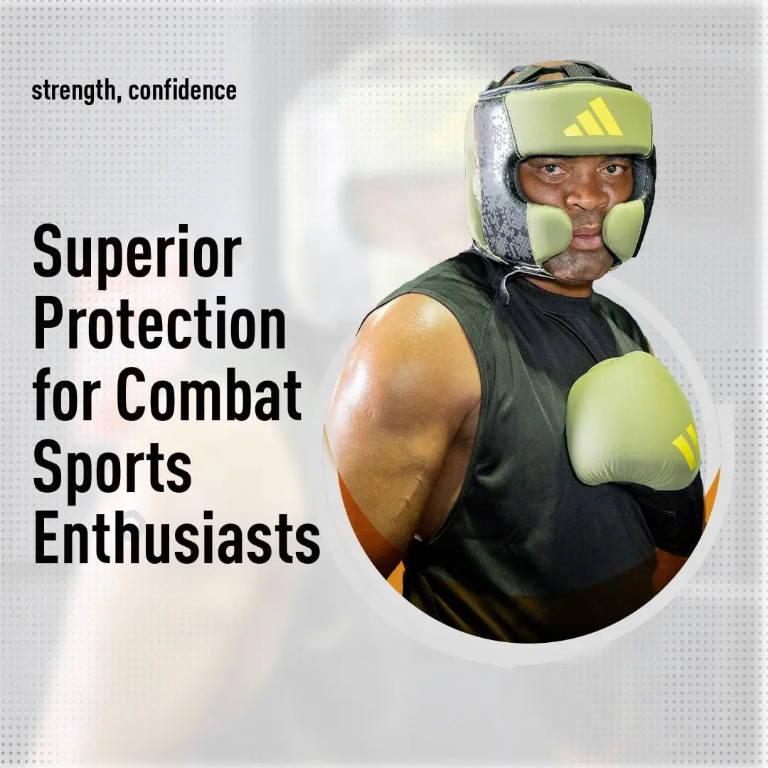 Man wearing boxing gloves and helmet, featuring Adidas x Anderson Silva head guard.