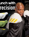 A man wearing Adidas x Anderson Silva Tilt150 boxing gloves.