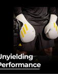 A person wearing Adidas x Anderson Silva Tilt150 boxing gloves.