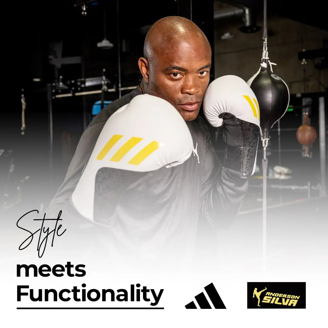 A man wearing Adidas x Anderson Silva Tilt150 boxing gloves.