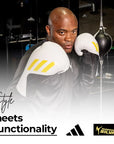 A man wearing Adidas x Anderson Silva Tilt150 boxing gloves.