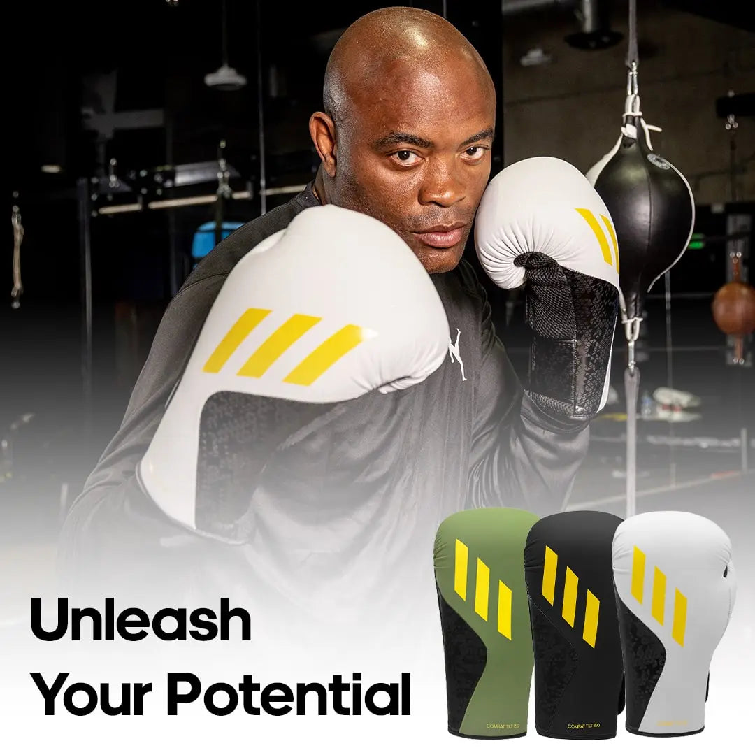 A man wearing Adidas x Anderson Silva Tilt150 boxing gloves.