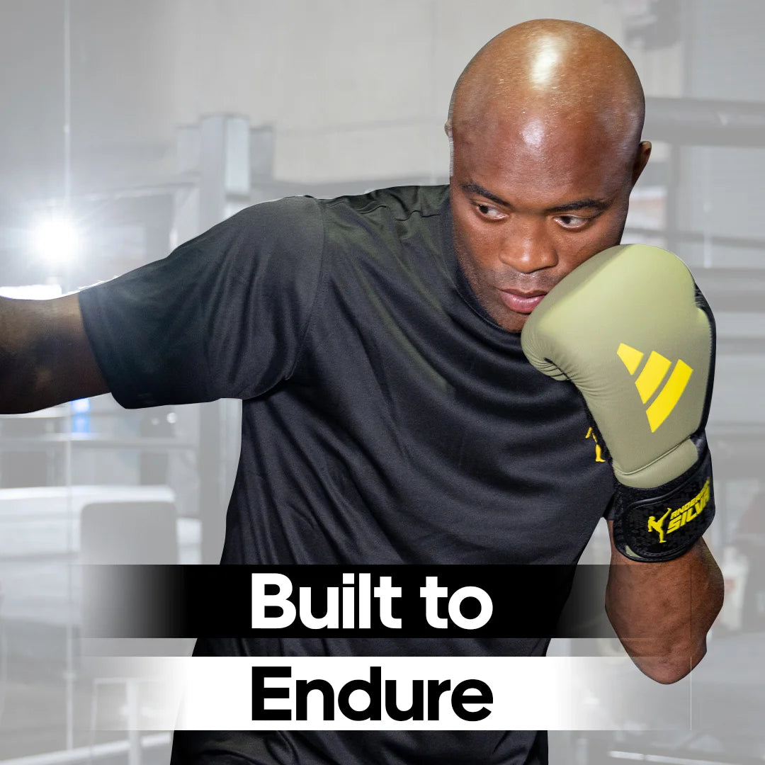 A man wearing Adidas x Anderson Silva boxing gloves.