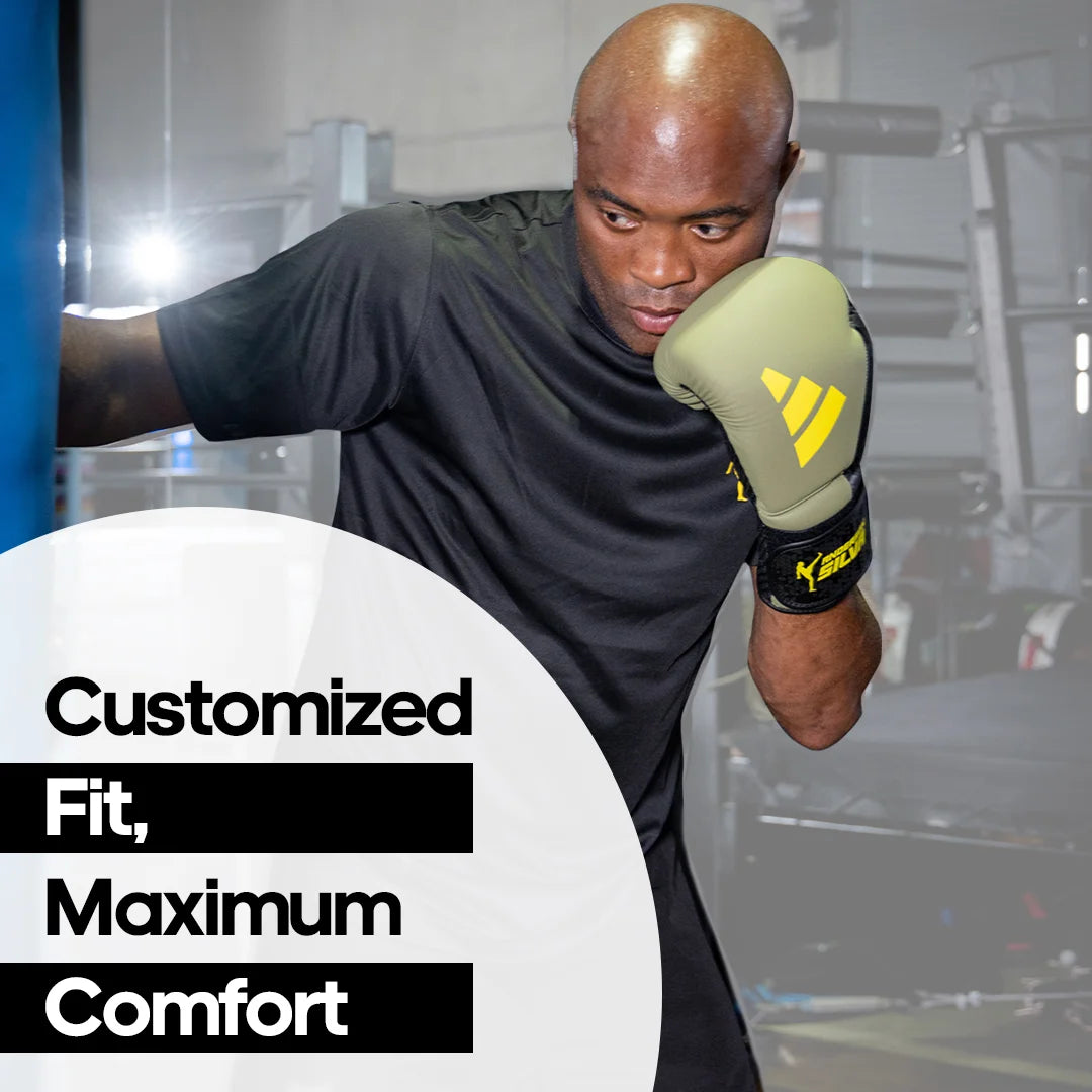 A man wearing Adidas x Anderson Silva boxing gloves.