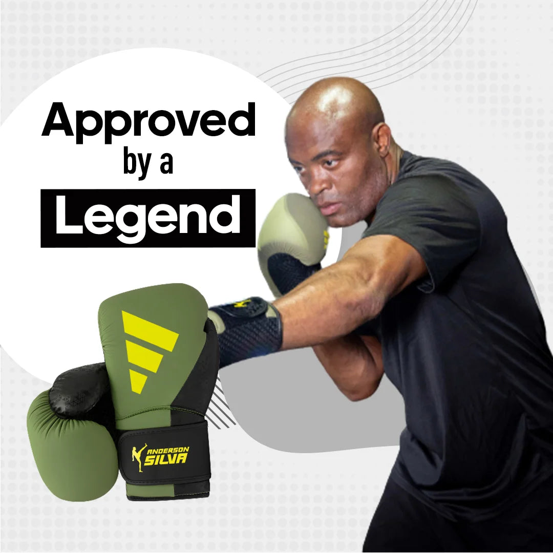 A man wearing Adidas x Anderson Silva boxing gloves.