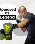 A man wearing Adidas x Anderson Silva boxing gloves.