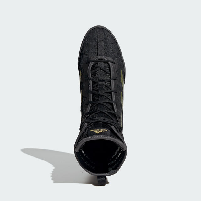 Black shoe with yellow laces and gold details.