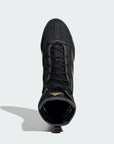 Black shoe with yellow laces and gold details.