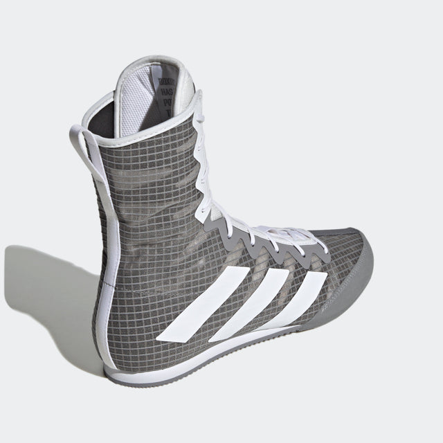 Grey and white high top shoe for boxing.