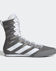 Grey and white high top shoe for boxing.