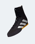 Black shoe with white stripes, ideal for boxing.