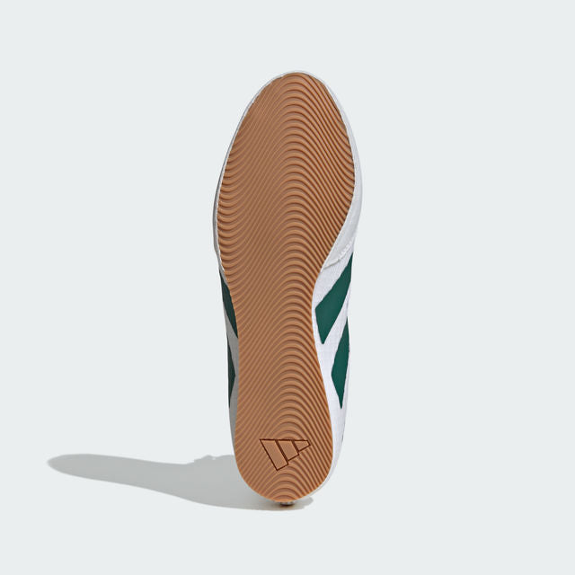 Close-up of a shoe sole with a brown tread pattern on a white background