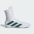 White boxing shoe with green stripes on a light gray background