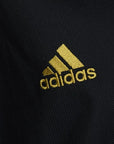 Black shirt with yellow logo from Adidas.