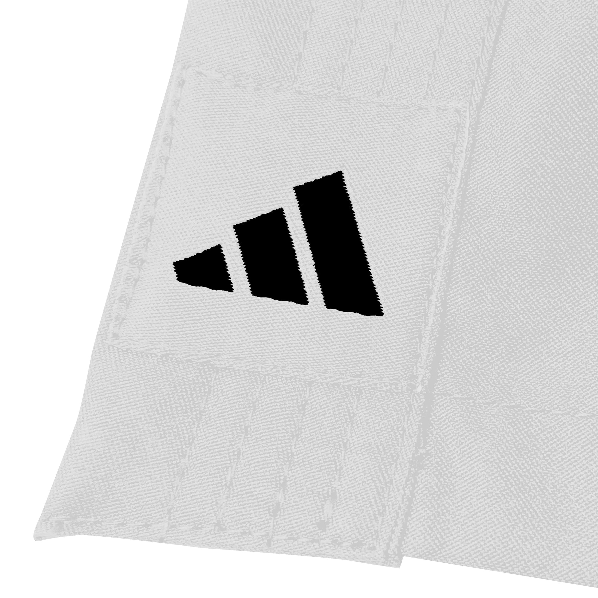 Close-up of a white fabric with black Adidas logo on a white background