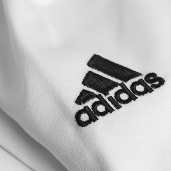 Close-up of a white karate shirt, part of the Adidas K200 karate uniform.