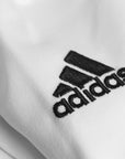 Close-up of a white karate shirt, part of the Adidas K200 karate uniform.