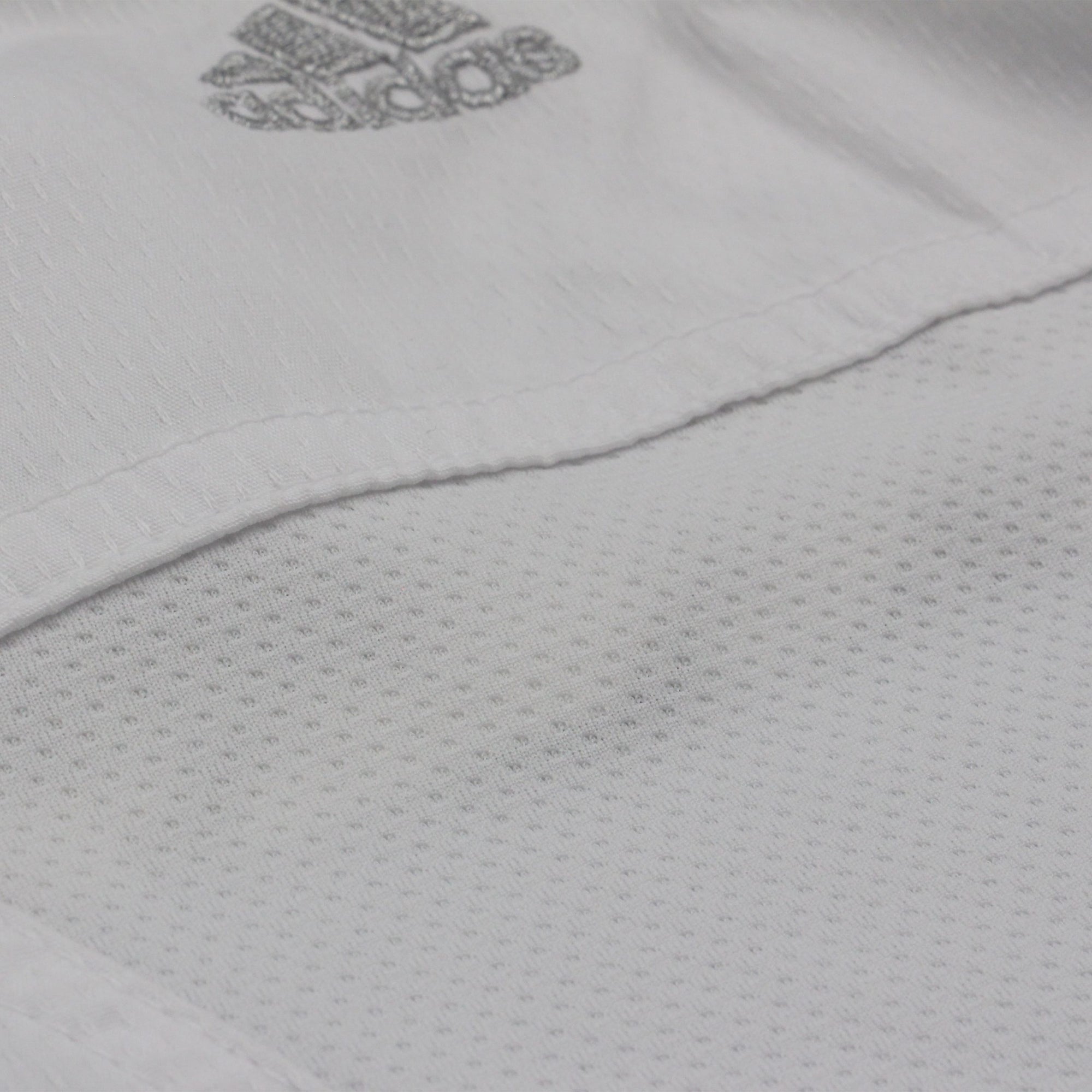 A close-up view of the Adidas Kumite Fighter K220KF karate uniform jersey.