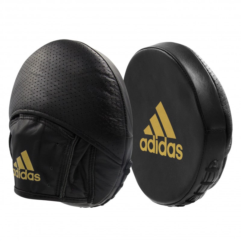 Pair of black boxing pads with gold details.