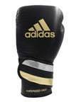 Black and gold Adidas boxing glove, metallic black, gold, silver, 10 oz.