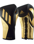 Metallic gold and black adidas Speed Tilt 750 fight gloves.