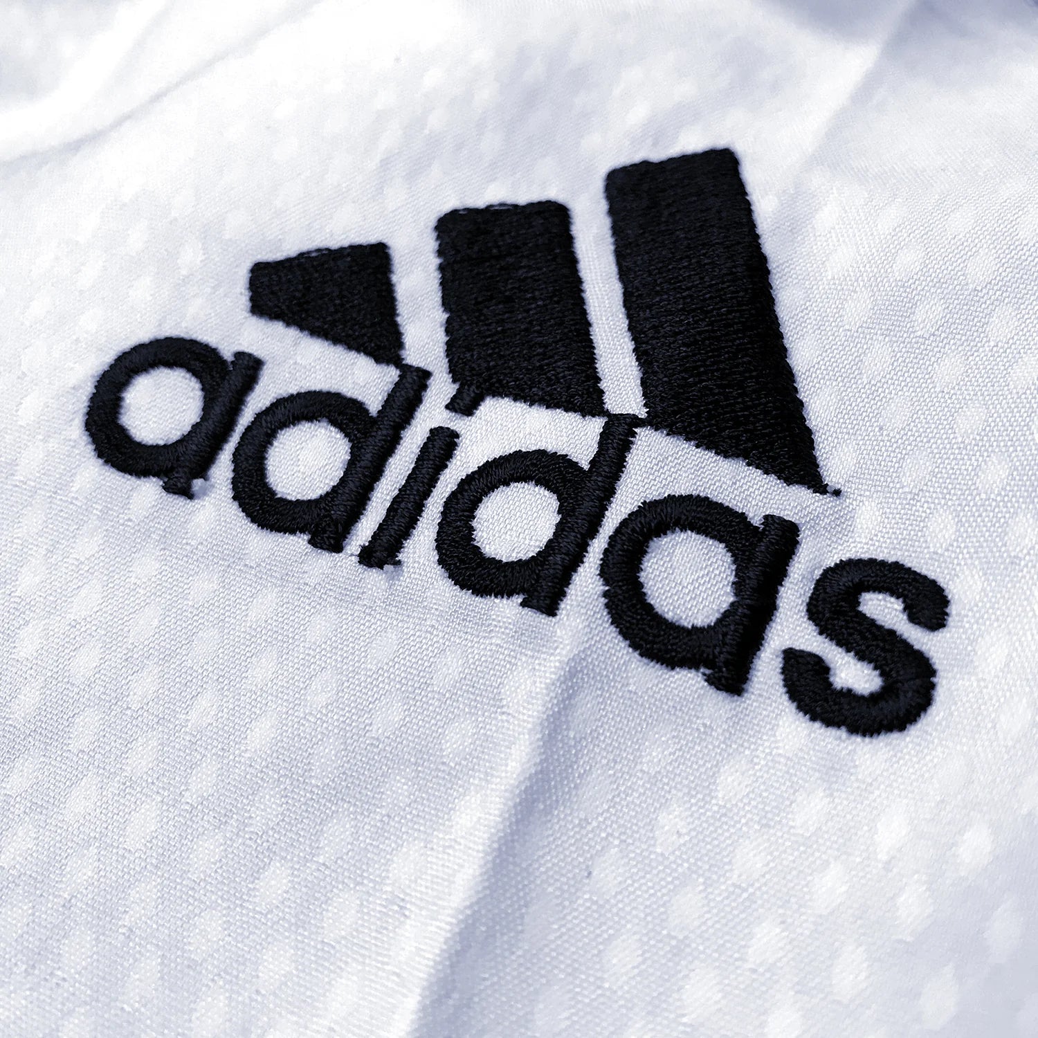 Close up of a logo on adidas Taekwondo Eco Fighter Uniform.