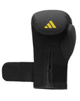 Adidas x Anderson Silva black boxing glove with yellow logo, 16 oz size.